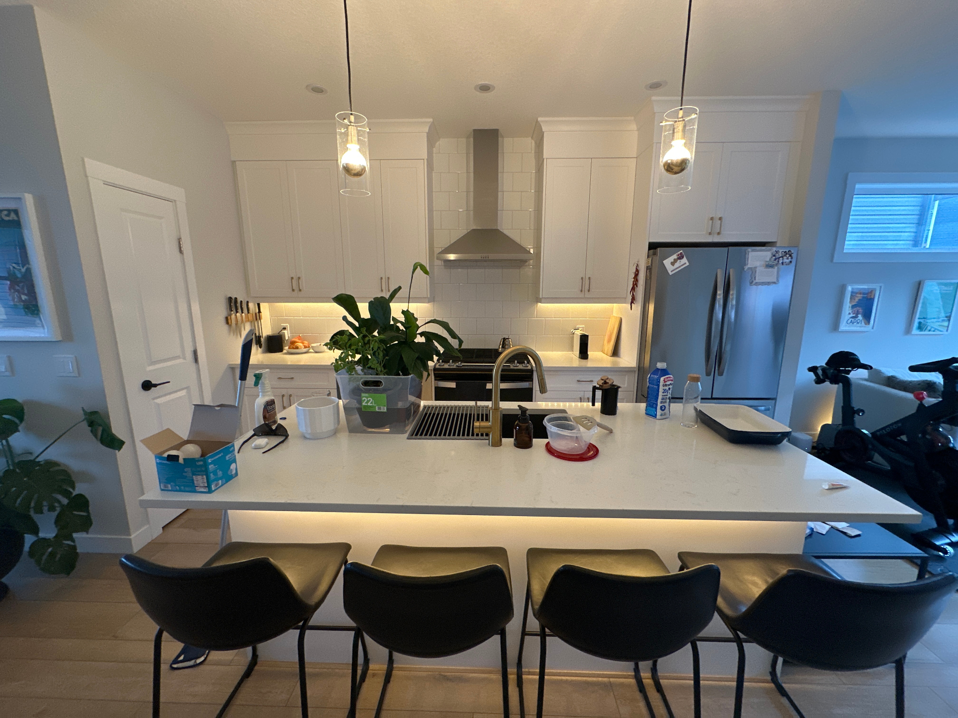 Original phone photo of a cluttered kitchen with warm indoor light